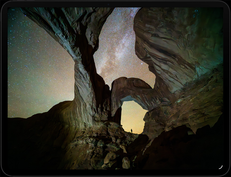 iPad Pro, display with image of 2 people entering a futuristic interior in the Apple TV series Silo.