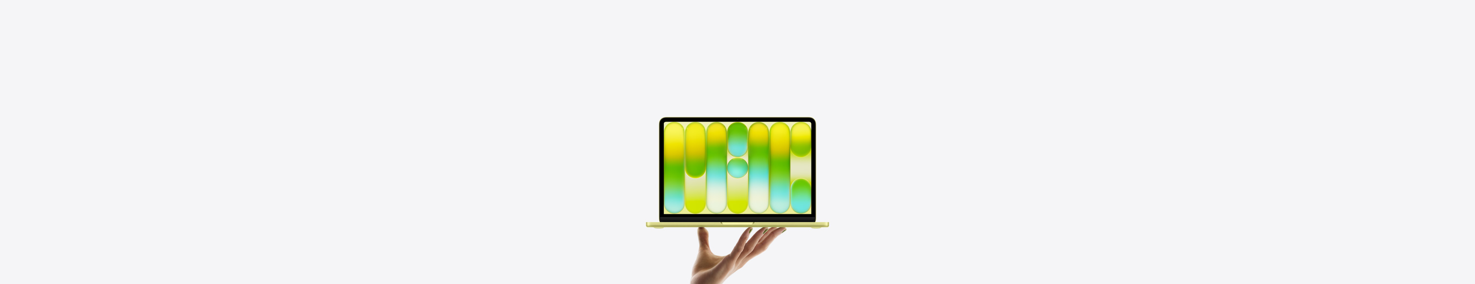 MacBook Neo in bright citrus color, balanced on fingertips of open hand, screen displaying colorful abstract pattern