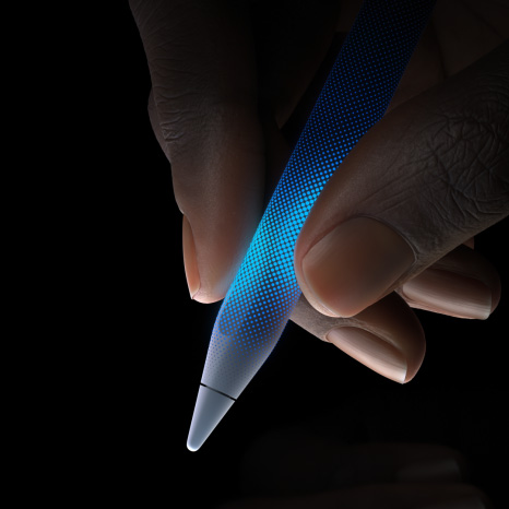 Apple Pencil Pro, side exterior, white color, thin profile, textured grip, hand holding with tip pointing down illustrating touch-sensitivity and haptic feedback