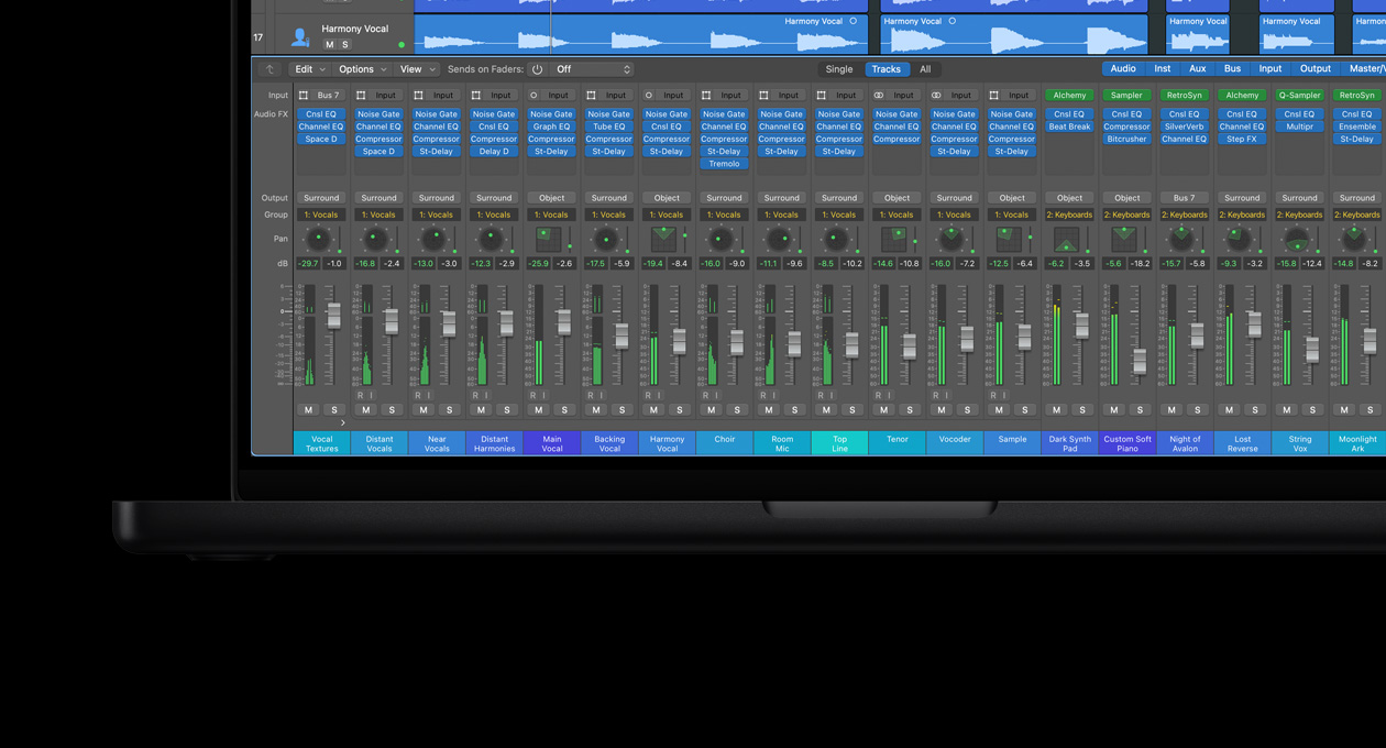 MacBook Pro 16, 24 track mixing board with faders, instruments arranged along bottom